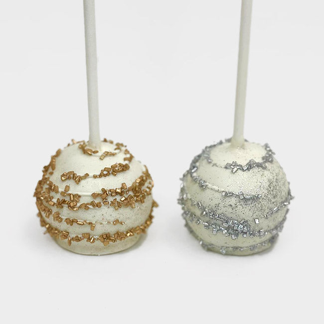 Two white Cake Pops; one decorated in silver and the other one in gold