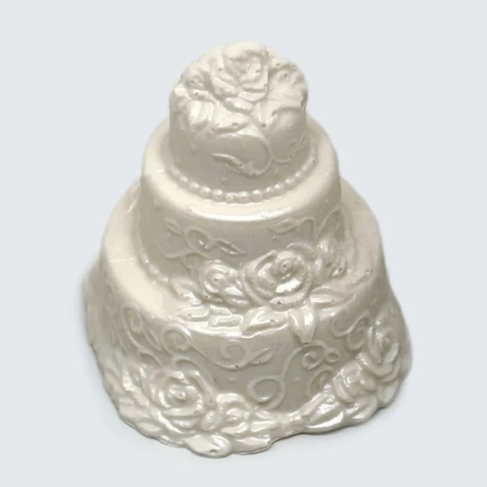 A white three tier Small Chocolate Wedding Cake decorated with white flowers and pearls