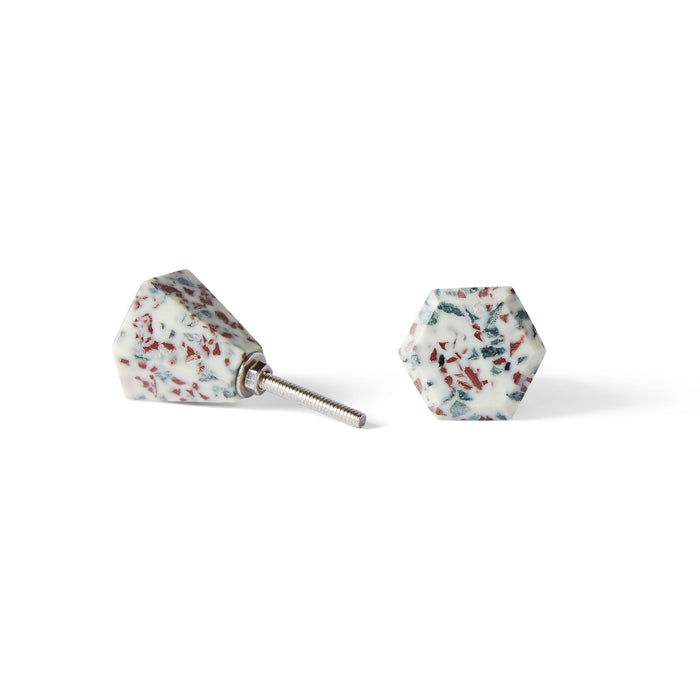 A set of two Speckle Geo Knob 3.8cm cabinet knobs with a white base, multicolored speckles, and metal screw fittingsβideal for adding a stylish hexagonal accent to your space.