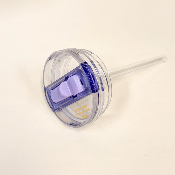 The Darling Effect 20 oz Periwinkle Lifestyle Flip Straw Replacement Lid features a clear plastic design with an attached straw and built-in purple sliding closure, offering a stylish, leak-resistant upgrade for your tumbler.