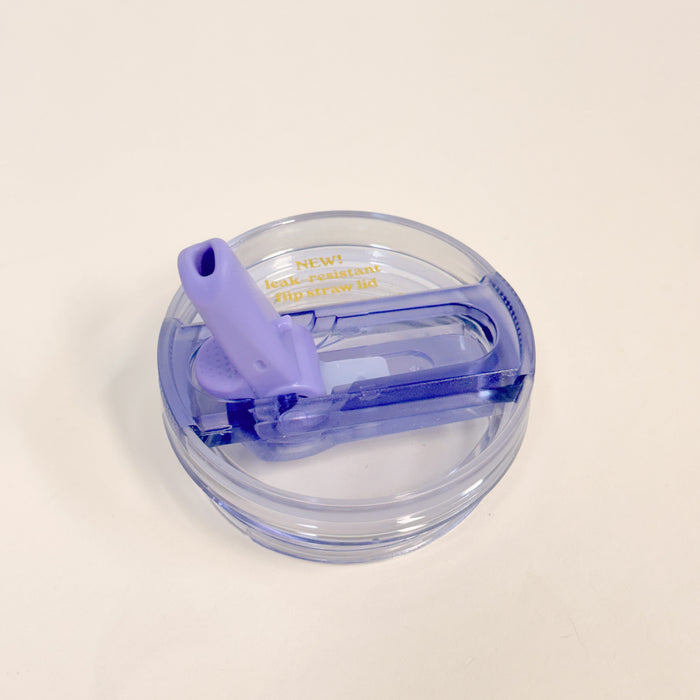 The Darling Effect's 20 oz Periwinkle Lifestyle Flip Straw Replacement Lid features a round, transparent design with a purple flip-up straw and gold "NEW! leak-resistant flip straw lid" text, shown on a white background.
