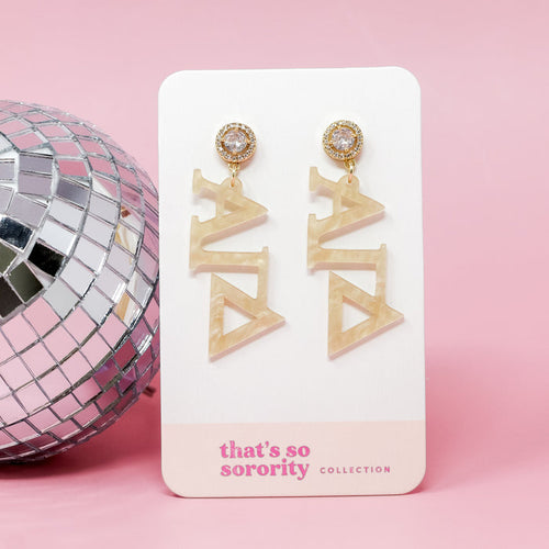 Alpha Gamma Delta Letter Gold Acrylic Earrings by The Darling Effect, shown on a branded card against a pink background with a silver disco ball—perfect for sisterhood events or as a fun addition to any bid day basket.