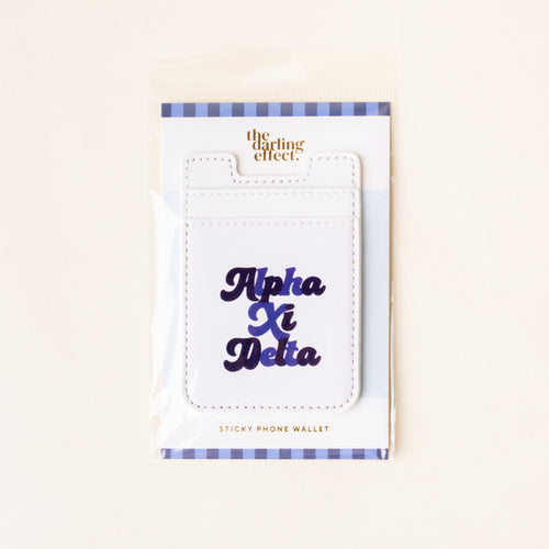 The Alpha Xi Delta Stick-On Phone Wallet by The Darling Effect features navy blue cursive lettering, a blue and white striped border, and comes in packaging—making it an ideal sorority gift.