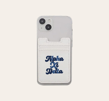 The Darling Effect Alpha Xi Delta Stick-On Phone Wallet in white attaches to a clear smartphone case and features bold dark blue script—an ideal sorority gift.