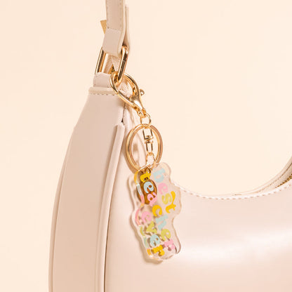 The-darling-effect's Best Teacher Ever Acrylic Keychain is a pocket-sized cream accessory, featuring pastel block letters and a translucent bear charm—making it a super cute gift for teachers.