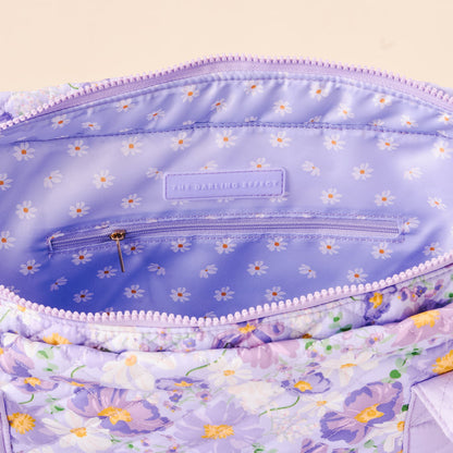 The Everyday Quilted Tote Bag by the-darling-effect features a bouquet-inspired lavender design with a lilac interior, white daisy lining, zippered pocket, and signature label—perfect as your daily carry-all.