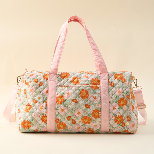 The-darling-effect’s Bouquet Beauty Sage On-the-Go Quilted Weekender Bag features a pastel floral print and pink straps—making it the perfect travel bag for your next getaway.