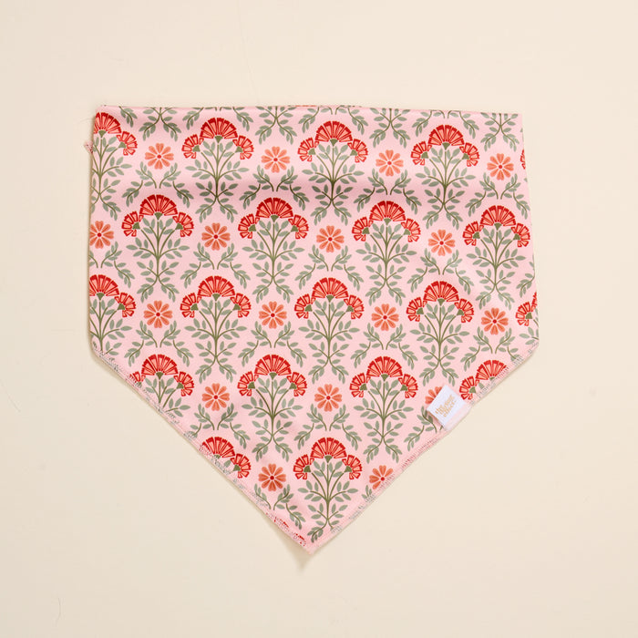 The Darling Effect’s Bow-Wow Pet Bandana-Everbloom Dusty Rose features a floral design in pink and red with green stems—an ideal stylish accessory for fashionable dogs and their pet parents.