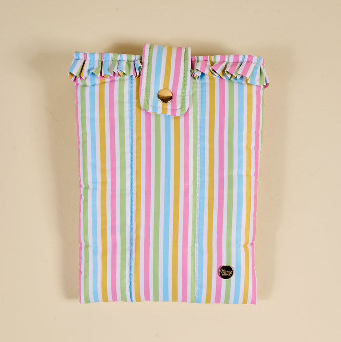 The Darling Effect's Color Me Happy Book Cover is a puffy polyester cover with vertical pastel stripes, a ruffled top trim, flap with gold button closure, and a small round black logo patch for cute book protection.