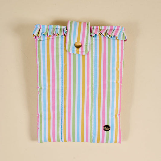The Darling Effect's Color Me Happy Book Cover is a puffy polyester cover with vertical pastel stripes, a ruffled top trim, flap with gold button closure, and a small round black logo patch for cute book protection.