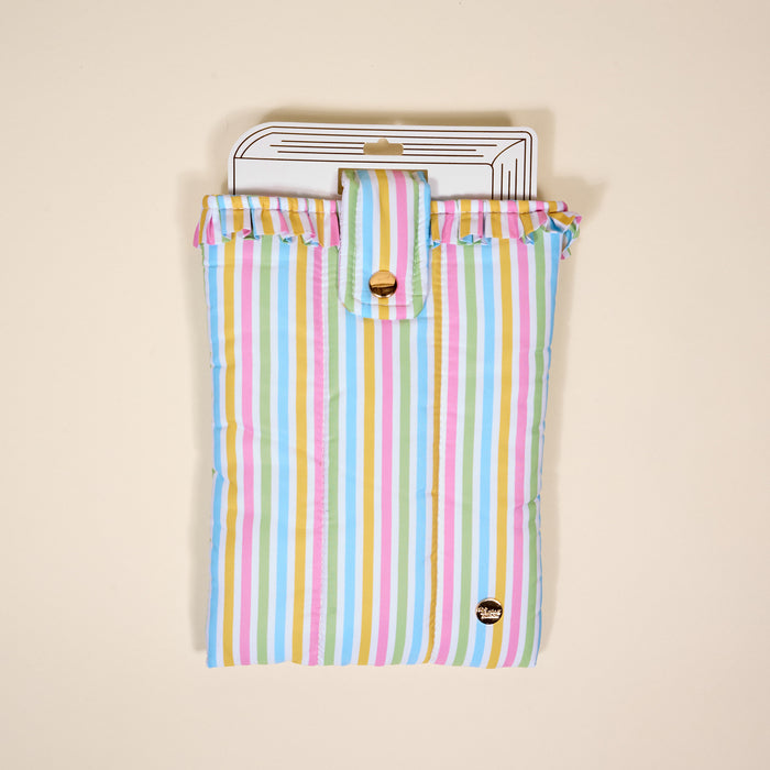 The Darling Effect’s Color Me Happy Book Cover features pastel stripes, ruffled edges, and a gold snap closure—a cute puffy polyester pouch that protects your books in style.