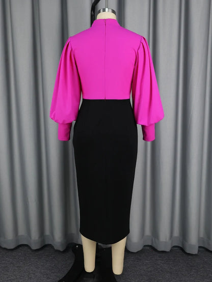 Mannequin wearing a bright pink top and black skirt against a gray curtain background