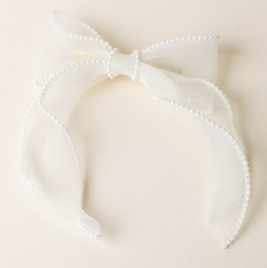 The-darling-effect’s Cream Sheer Pearl Hair Bow features a large pearl-adorned bow, perfect for bringing elegance to your hair accessory collection.