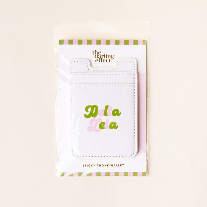 The Delta Zeta Stick-On Phone Wallet by The Darling Effect features white material with Delta Zeta in green and pink, packaged in a clear bag with light green and pink stripes—perfect as a cute sorority gift.