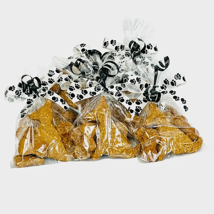 Meeko's dog and bow Treats, packaged in a cellophane bag and tied with ribbons.