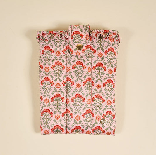 The Everbloom Dusty Rose Book Cover features a puffy polyester design with red and green floral patterns on a light pink background, a snap button flap closure, and is shown against a beige backdrop for stylish book protection.