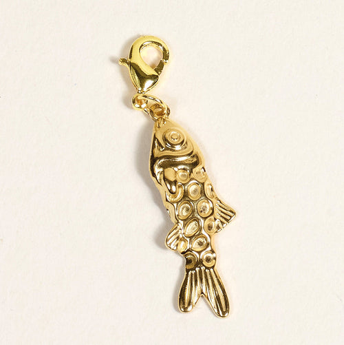 The Darling Effect Fish Jewelry Charm Gold features a textured, scale-like pattern and a lobster clasp, ideal for charm bars or layering necklaces. Shown against a plain light background.