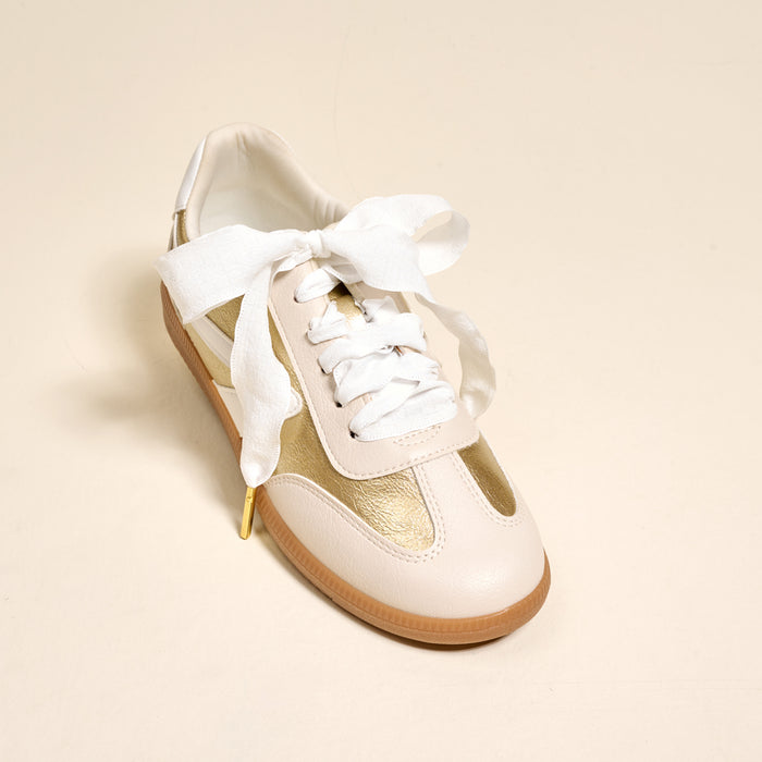 The Darling Effect’s Frilly White Step It Up Shoelaces add a touch of elegance to sneakers with their durable white ribbon laces, tied in a neat bow.