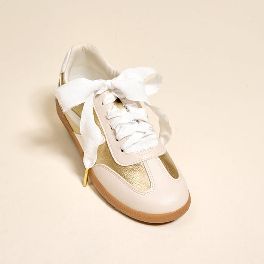 The Darling Effect’s Frilly White Step It Up Shoelaces add a touch of elegance to sneakers with their durable white ribbon laces, tied in a neat bow.