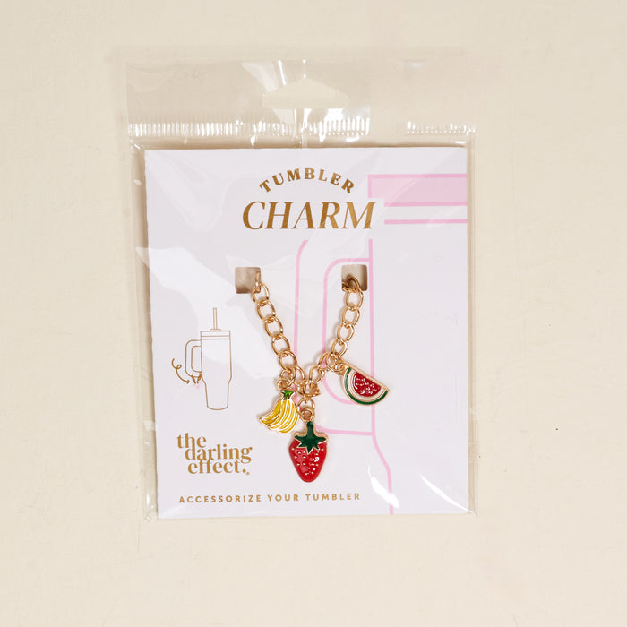 The Fruit Fusion Tumbler Charm by the-darling-effect includes a gold chain with banana, strawberry, and watermelon charms on a white "Tumbler Charm" card—fun accessories to brighten up your drinkware.