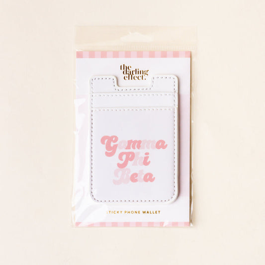 The Darling Effect Gamma Phi Beta Stick-On Phone Wallet is white with pink text and comes on a pink and white striped card—perfect for carrying essentials in style.