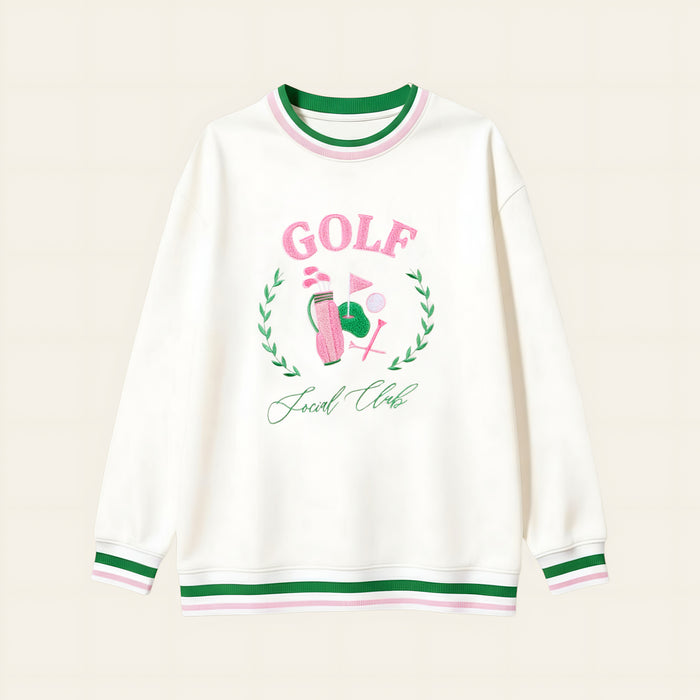 The Darling Effect’s Golf Social Club Oversized Crew features green and pink striped cuffs and collar, a golf-themed embroidered design with "GOLF" in pink letters, a golf ball, flag, and "Social Club" underneath.