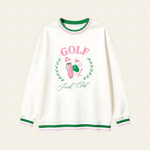 The Darling Effect’s Golf Social Club Oversized Crew features green and pink striped cuffs and collar, a golf-themed embroidered design with "GOLF" in pink letters, a golf ball, flag, and "Social Club" underneath.