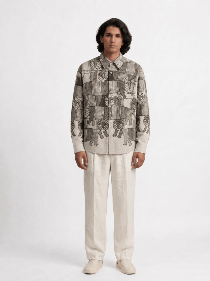 Man wearing the Gond Forest shirt with cream trousers, front view