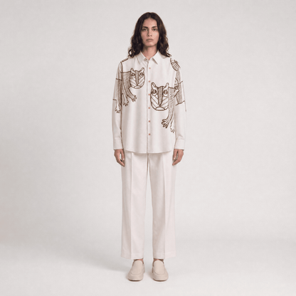 Woman wearing the off white Gond Tiger shirt with white trousers, full length front view