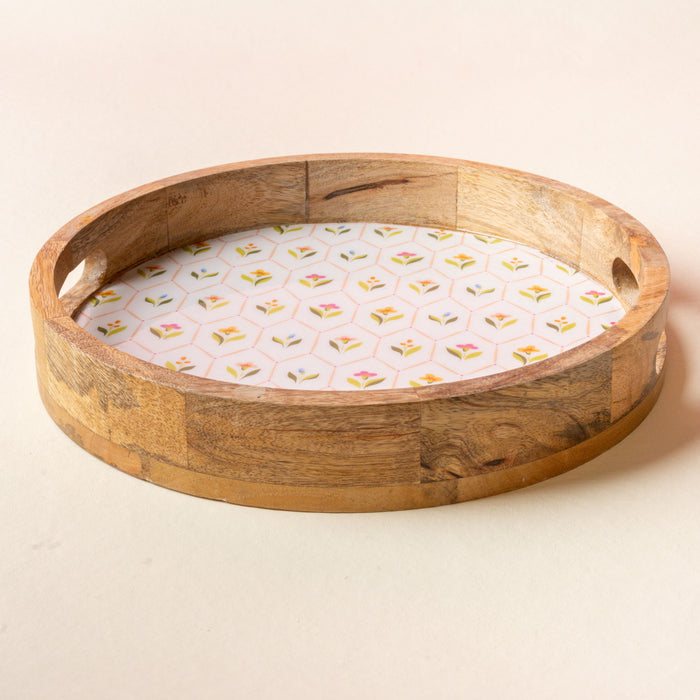 The-darling-effect’s Handpicked For You Large Round Wood Enamel Tray features integrated handles and a white insert with a pastel floral pattern, perfect as a decorative piece or for serving.
