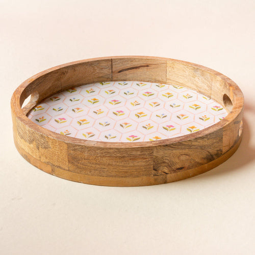 The-darling-effect’s Handpicked For You Large Round Wood Enamel Tray features integrated handles and a white insert with a pastel floral pattern, perfect as a decorative piece or for serving.
