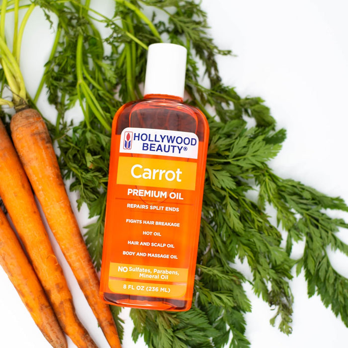 Hollywood Beauty Carrot Premium Oil 8oz / 236ml displayed with fresh carrots, a sulphate-, paraben- and mineral oil-free treatment for split ends, hair breakage, scalp care and body massage
