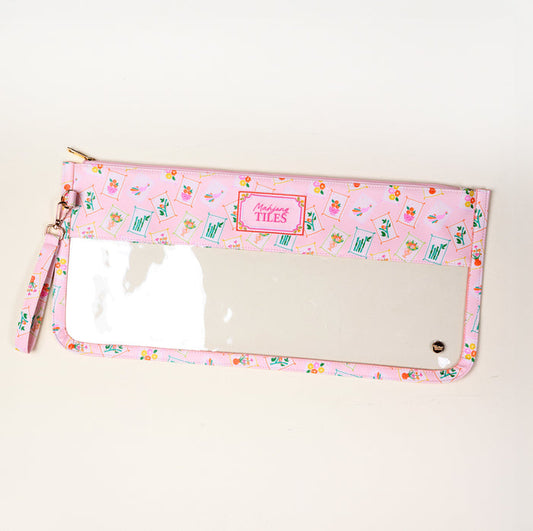 The Darling Effect's It's Mahj Time Pink Mahjong Tile Keeper Pouch features a floral-geometric design, clear front pocket, gold zipper, wrist strap, and a "Mahjong TILES" label—ideal for storing your Mahjong tiles in style.