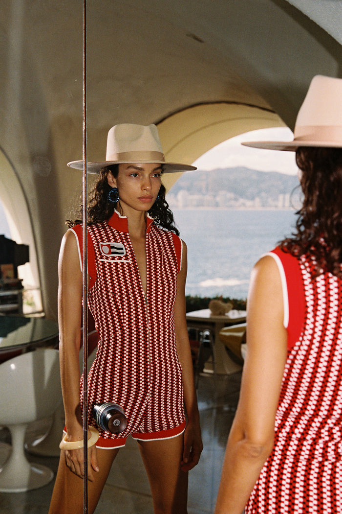 Model wearing an Ivory Rancher wool felt fedora hat, standing in front of a mirror with a scenic background.