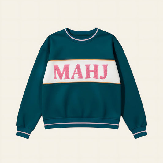 The Darling Effect Mahj Signature Crew features pink textured MAHJ letters on a white stripe with golden-brown borders, plus pink and white striped cuffs and collar for cozy, all-day comfort.