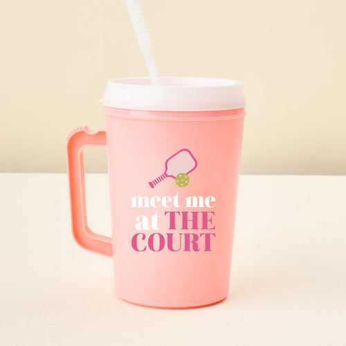 The-darling-effect Meet Me on the Court 34 oz Mega Mug: a pink plastic tumbler with handle, white lid and straw, plus a paddle and ball graphic above "meet me at THE COURT"—ideal for hydration on or off the court.