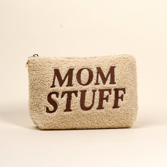 The Darling Effect’s Mom Stuff Teddy Pouch is a cream sherpa pouch with “MOM STUFF” in bold brown letters—cute, stylish, and perfect for organizing essentials.