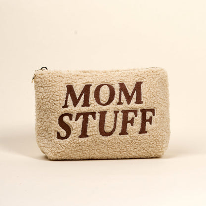 The Darling Effect’s Mom Stuff Teddy Pouch is a cream sherpa pouch with “MOM STUFF” in bold brown letters—cute, stylish, and perfect for organizing essentials.