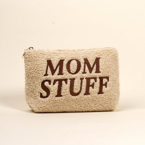 The Darling Effect’s Mom Stuff Teddy Pouch is a cream sherpa pouch with “MOM STUFF” in bold brown letters—cute, stylish, and perfect for organizing essentials.