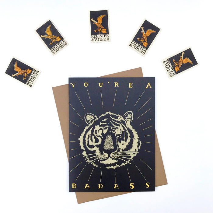 Greeting card with tiger design and text, surrounded by stamps.