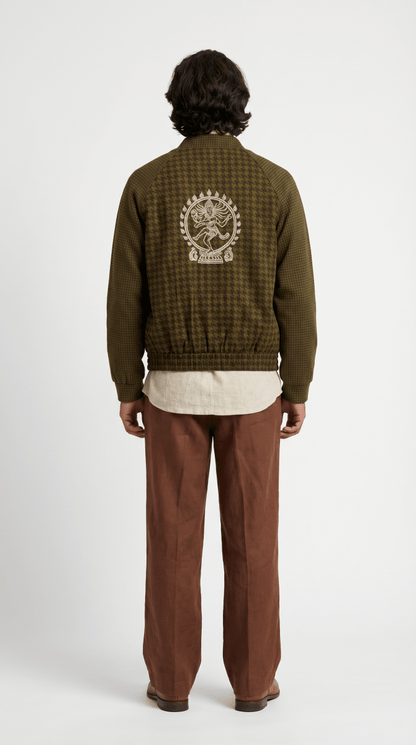 Man wearing the Natraj bomber-style jacket with brown trousers, back view, with a cream Nataraja figure