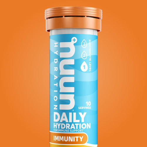 Tube of Nuun Immunity on an orange background.