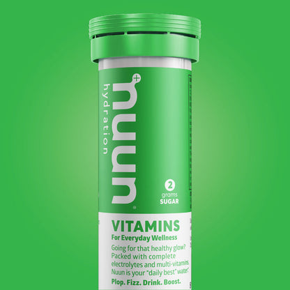 A tube of Nuun Vitamins on a green background.