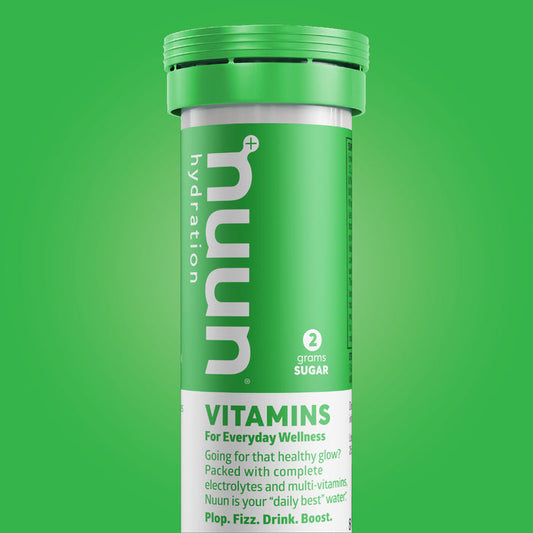 A tube of Nuun Vitamins on a green background.