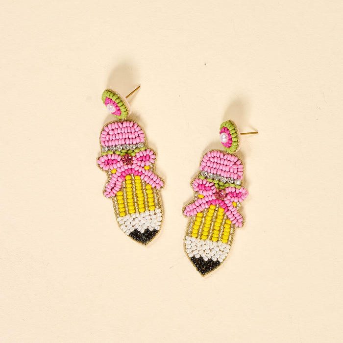 Add a playful touch to your jewelry collection with The Darling Effect's Pencil Me In Beaded Earrings—pencil-shaped, hand-beaded with pink tips, yellow barrels, green beads, and pink bows for extra charm.