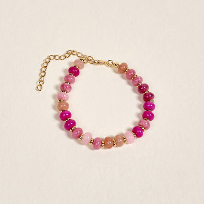 The Darling Effect's Pretty Pinks Stone Candy Bracelet features alternating pink, magenta, and gold beads with a gold adjustable chain clasp. Ideal for layering, this playful piece brightens any colorful jewelry collection.