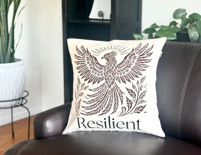 20" x 20" Decorative cotton Canvas pillow with a Rising Phoenix design and the word 'Resilient'. Hand-sewn & Hand-printed by Women Survivors in Kolkata, India.