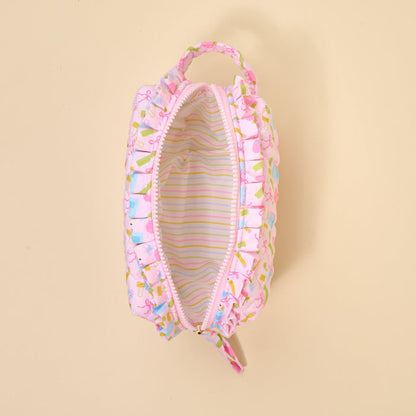 The Darling Effect's School's In Session Essentials Quilted Cosmetic Pouch features a pink ruffled design, zip closure, small handle, cute colorful exterior, and pastel striped lining shown from above with the zipper open.