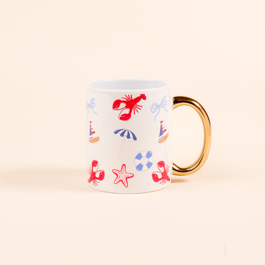 The Darling Effect’s Seaside Haven 11 oz Cozy Cute Ceramic Mug features a golden handle and vibrant illustrations of red lobsters, starfish, umbrellas, lifebuoys, and party hats on a light backdrop—perfect for coffee or tea.