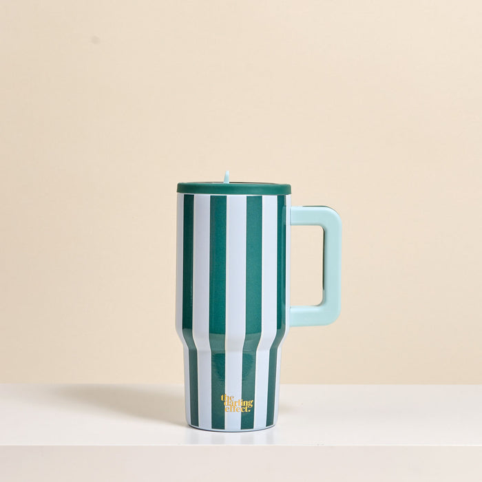 The Darling Effect Sicily Stripes Teal 20 oz Lifestyle Flip Straw Tumbler, featuring vertical green and white stripes, a light blue handle and lid, sits on a white surface. This insulated tumbler keeps drinks hot or cold for hours.